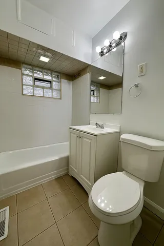 a bathroom with a sink a toilet and mirror