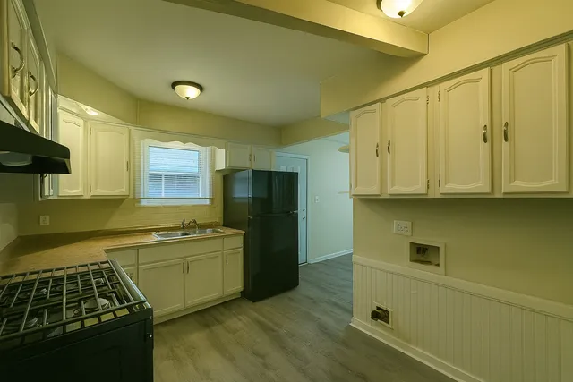 a kitchen that has a sink and a stove