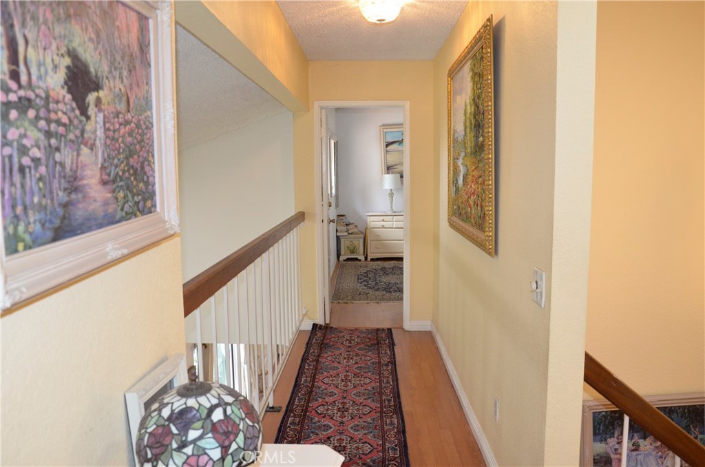 6574 Carioca Lane Riverside, CA 92506 - Photo 13 of 45 a view of a hallway with wooden floor and staircase