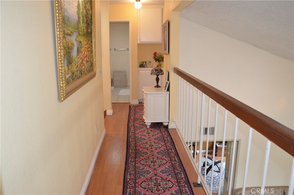 6574 Carioca Lane Riverside, CA 92506 - Photo 15 of 45 a view of a hallway with wooden floor and staircase