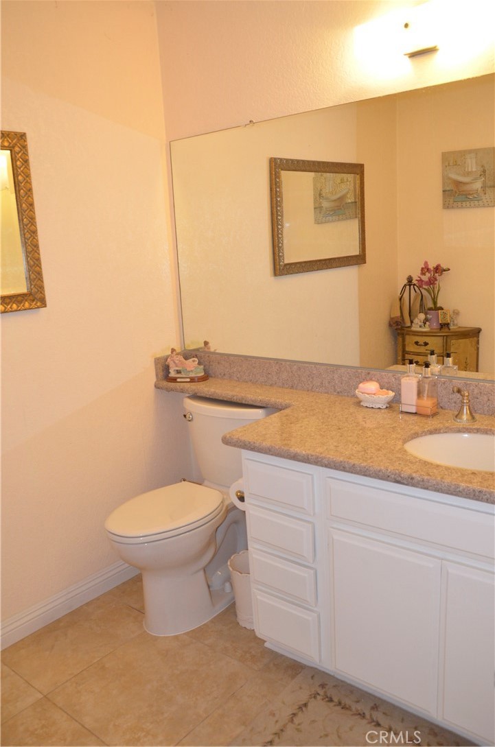 6574 Carioca Lane Riverside, CA 92506 - Photo 18 of 45 a bathroom with a granite countertop toilet and sink