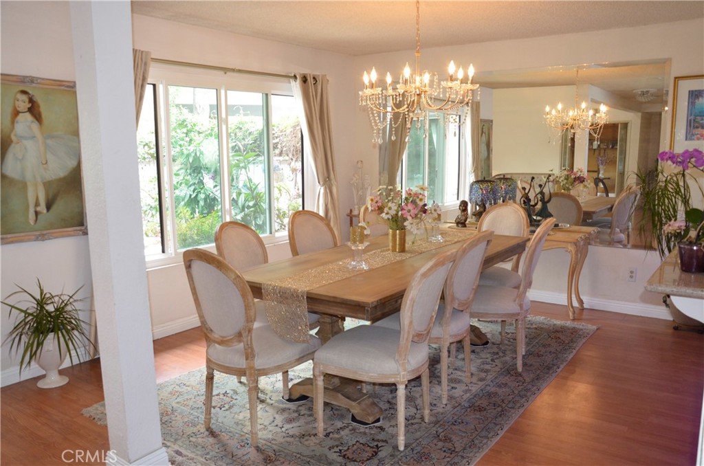 6574 Carioca Lane Riverside, CA 92506 - Photo 19 of 45 a view of a dining room with furniture a chandelier and wooden floor