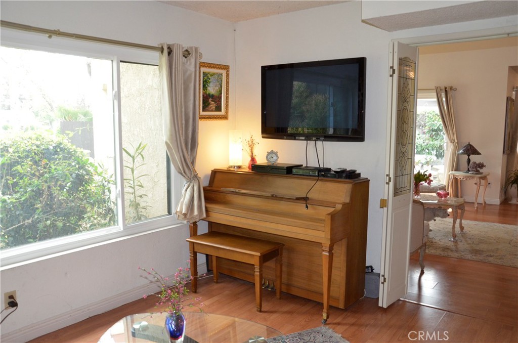 6574 Carioca Lane Riverside, CA 92506 - Photo 23 of 45 a living room with a flat screen tv and a floor to ceiling window