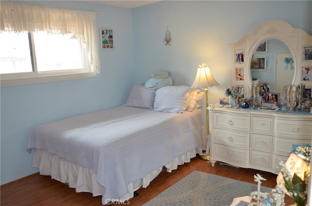 6574 Carioca Lane Riverside, CA 92506 - Photo 6 of 45 a bedroom with a bed and a dresser next to a window