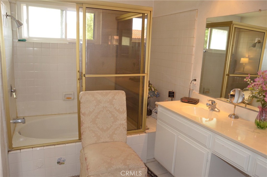 6574 Carioca Lane Riverside, CA 92506 - Photo 10 of 45 a bathroom with a granite countertop sink a mirror and a shower