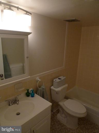 3000 7th Street Northeast, Unit 124 Washington, DC 20017 - Photo 11 of 27 a bathroom with a sink a toilet and a mirror