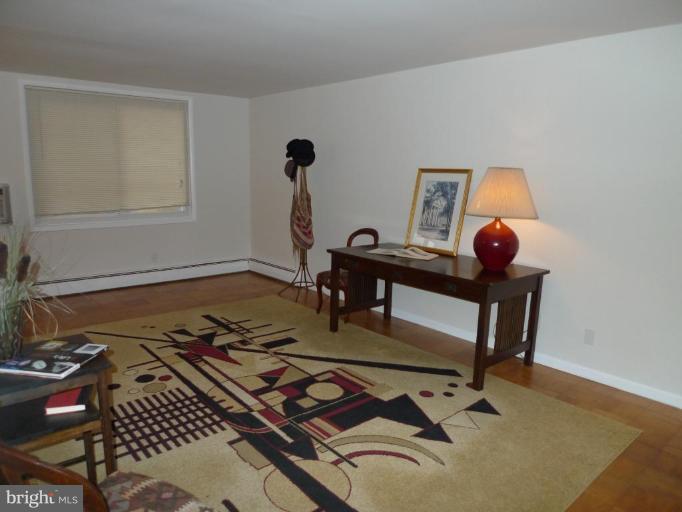 3000 7th Street Northeast, Unit 124 Washington, DC 20017 - Photo 16 of 27 a living room with furniture rug and window