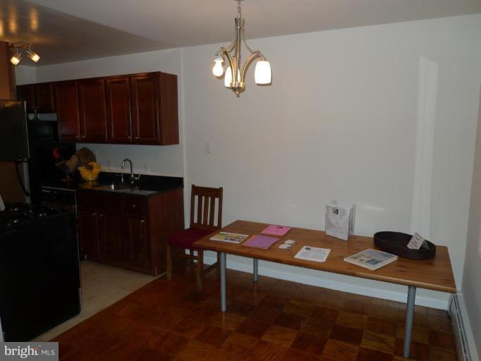 3000 7th Street Northeast, Unit 124 Washington, DC 20017 - Photo 19 of 27 a bedroom with a bed and a dresser in it