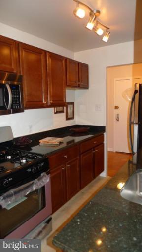 3000 7th Street Northeast, Unit 124 Washington, DC 20017 - Photo 3 of 27 a kitchen with stainless steel appliances granite countertop a stove a sink and a microwave