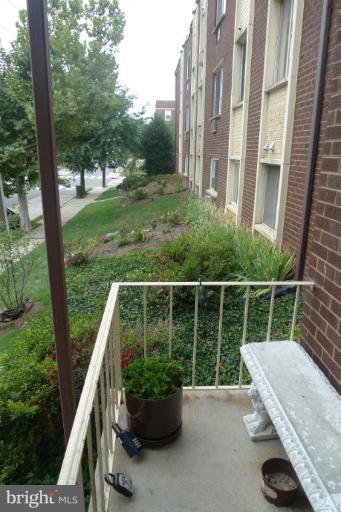 3000 7th Street Northeast, Unit 124 Washington, DC 20017 - Photo 23 of 27 a view of a chair and tables in the balcony