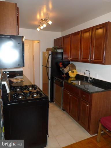 3000 7th Street Northeast, Unit 124 Washington, DC 20017 - Photo 4 of 27 a kitchen with stainless steel appliances granite countertop a refrigerator stove and sink