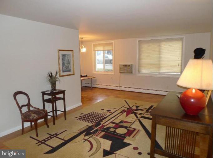 3000 7th Street Northeast, Unit 124 Washington, DC 20017 - Photo 8 of 27 a living room with furniture and a window