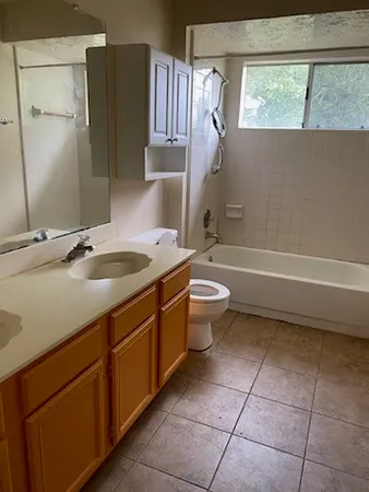 a bathroom with a sink a toilet and bathtub