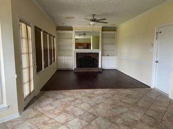 a view of a livingroom with a fireplace and window