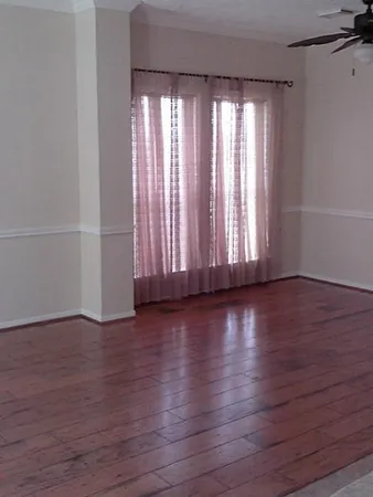 a view of wooden floor and windows in a room
