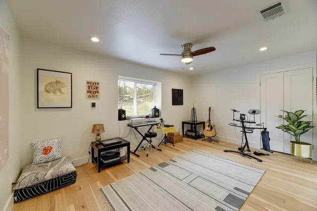 a living room with furniture a window and potted plants