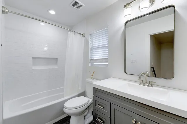 a bedroom with bed and windows