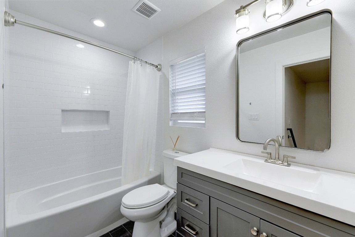 300 Lightsey Road, Unit 1 Austin, TX 78704 - Photo 17 of 21 a bathroom with a granite countertop sink a toilet and shower