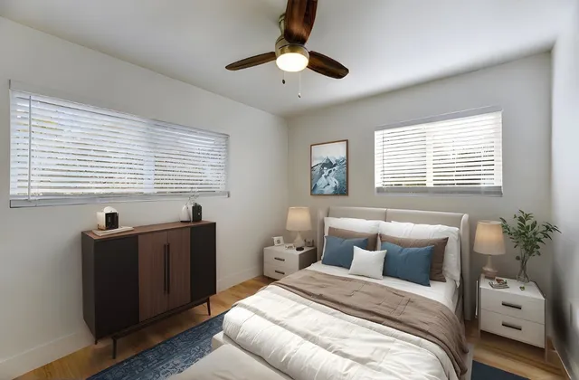 a bedroom with a bed and a painting on the wall