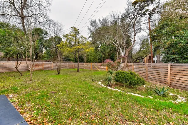 a house that has a tree in front of it