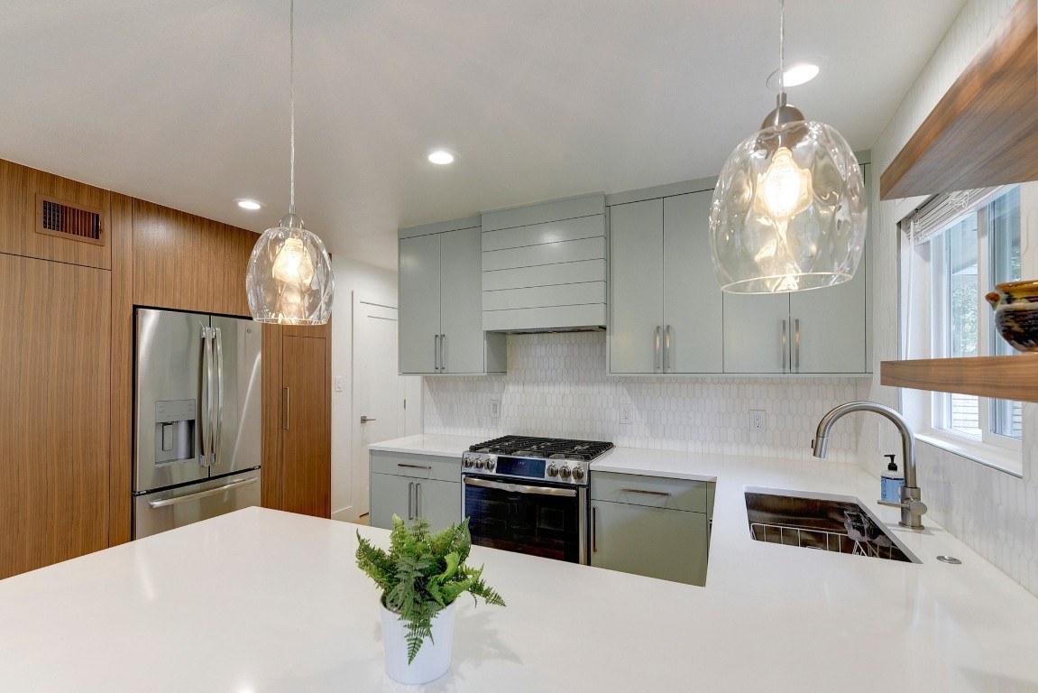 300 Lightsey Road, Unit 1 Austin, TX 78704 - Photo 4 of 21 a kitchen with granite countertop a stove a sink and a refrigerator