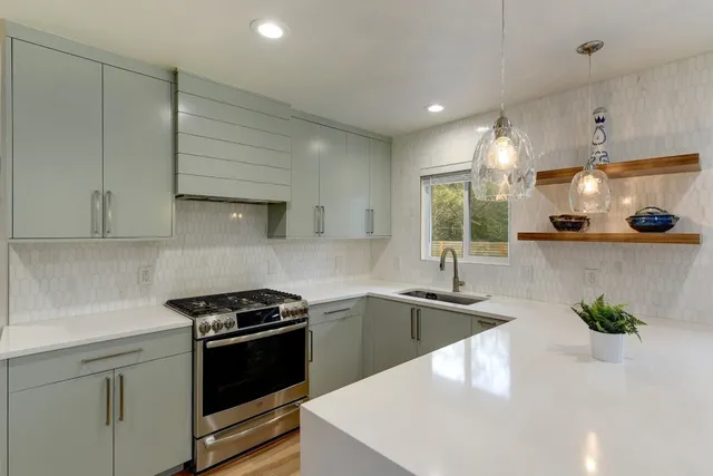 a kitchen that has a sink and a stove