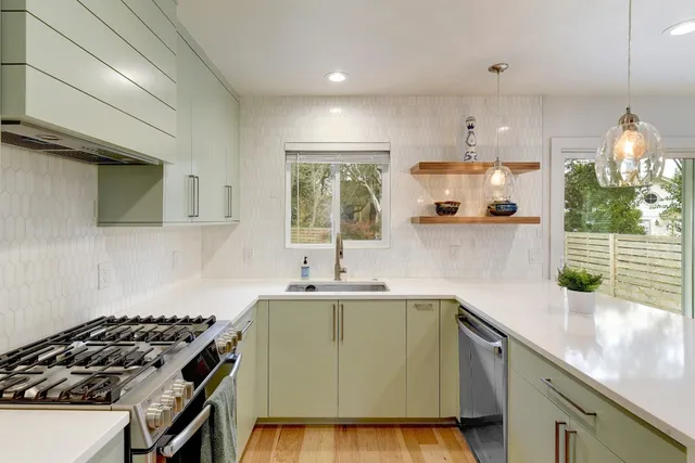 a kitchen with a sink a stove and a microwave