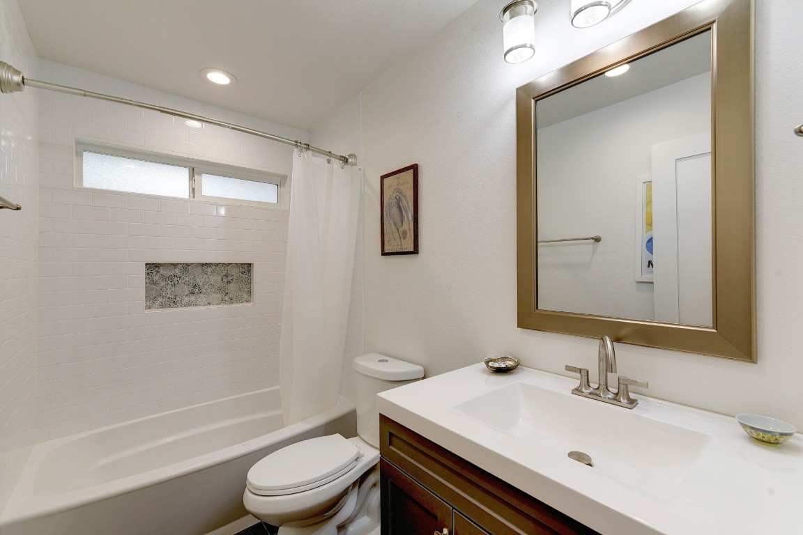 300 Lightsey Road, Unit 1 Austin, TX 78704 - Photo 8 of 21 a bathroom with a sink a toilet and shower