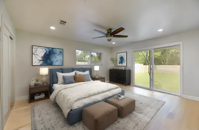 a spacious bedroom with a large bed and a large window