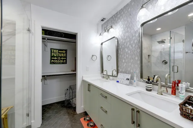 a bathroom with a sink a mirror and a shower