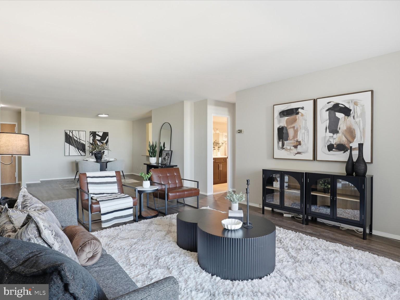 a living room with furniture and painting on the wall