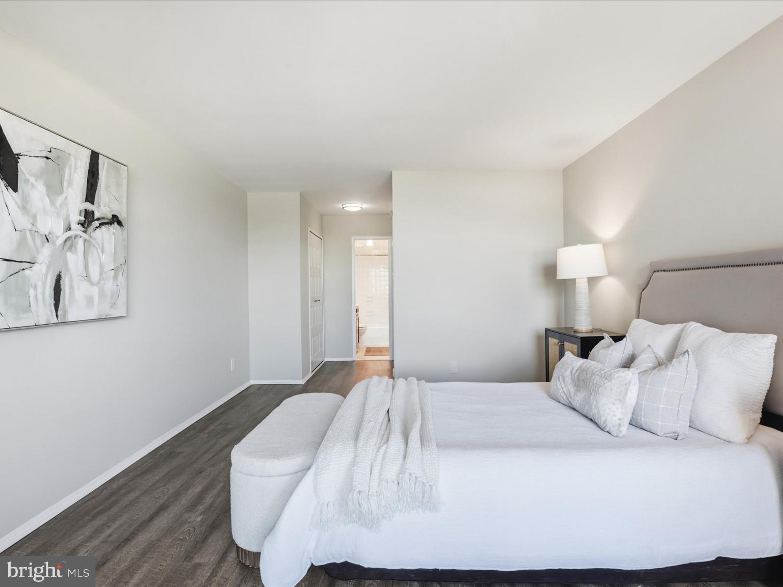 1800 Old Meadow Road, Unit 1017 McLean, VA 22102 - Photo 13 of 31 a bedroom with a bed and a lamp