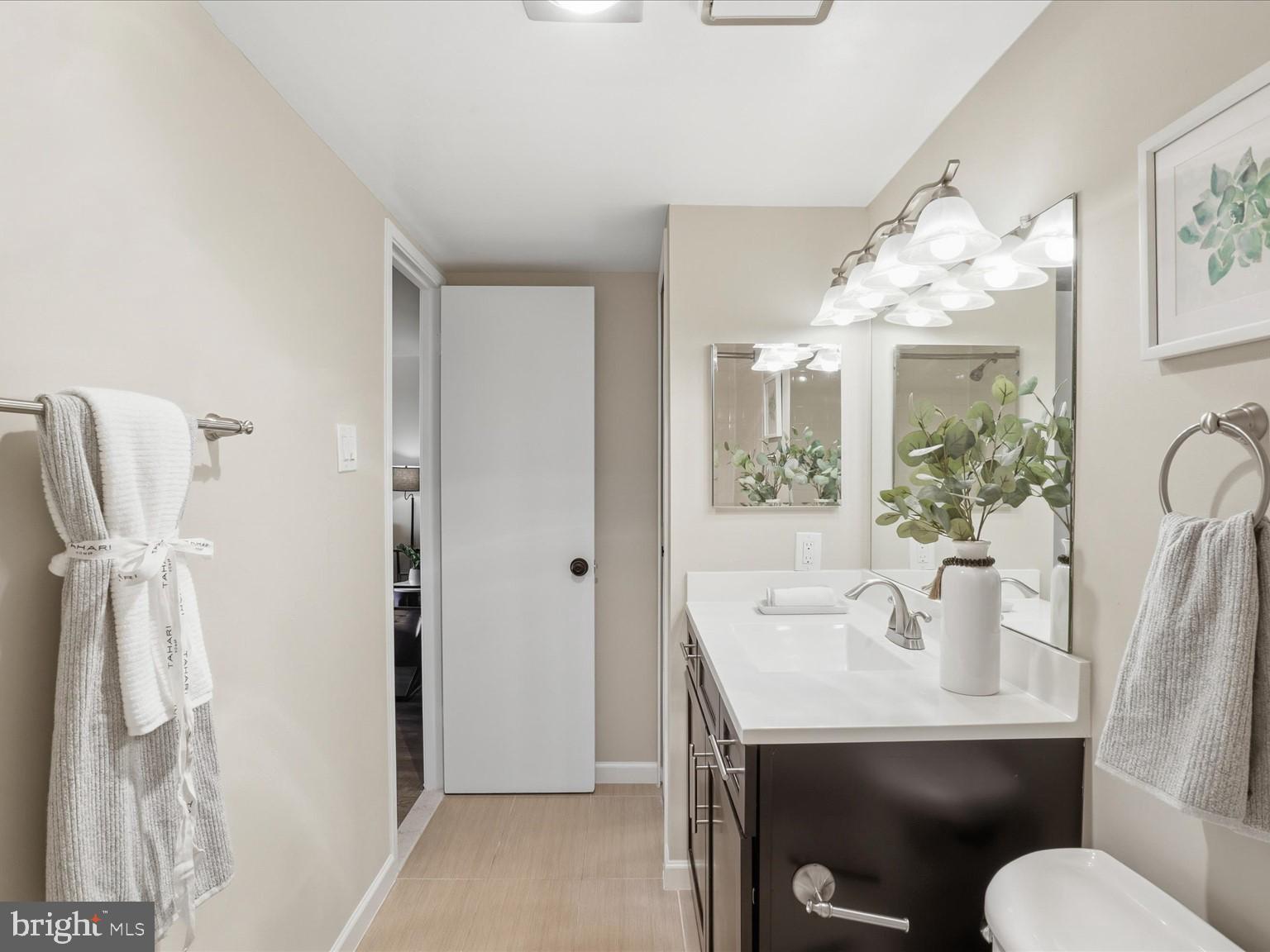 1800 Old Meadow Road, Unit 1017 McLean, VA 22102 - Photo 19 of 31 a bathroom with a sink mirror and toilet