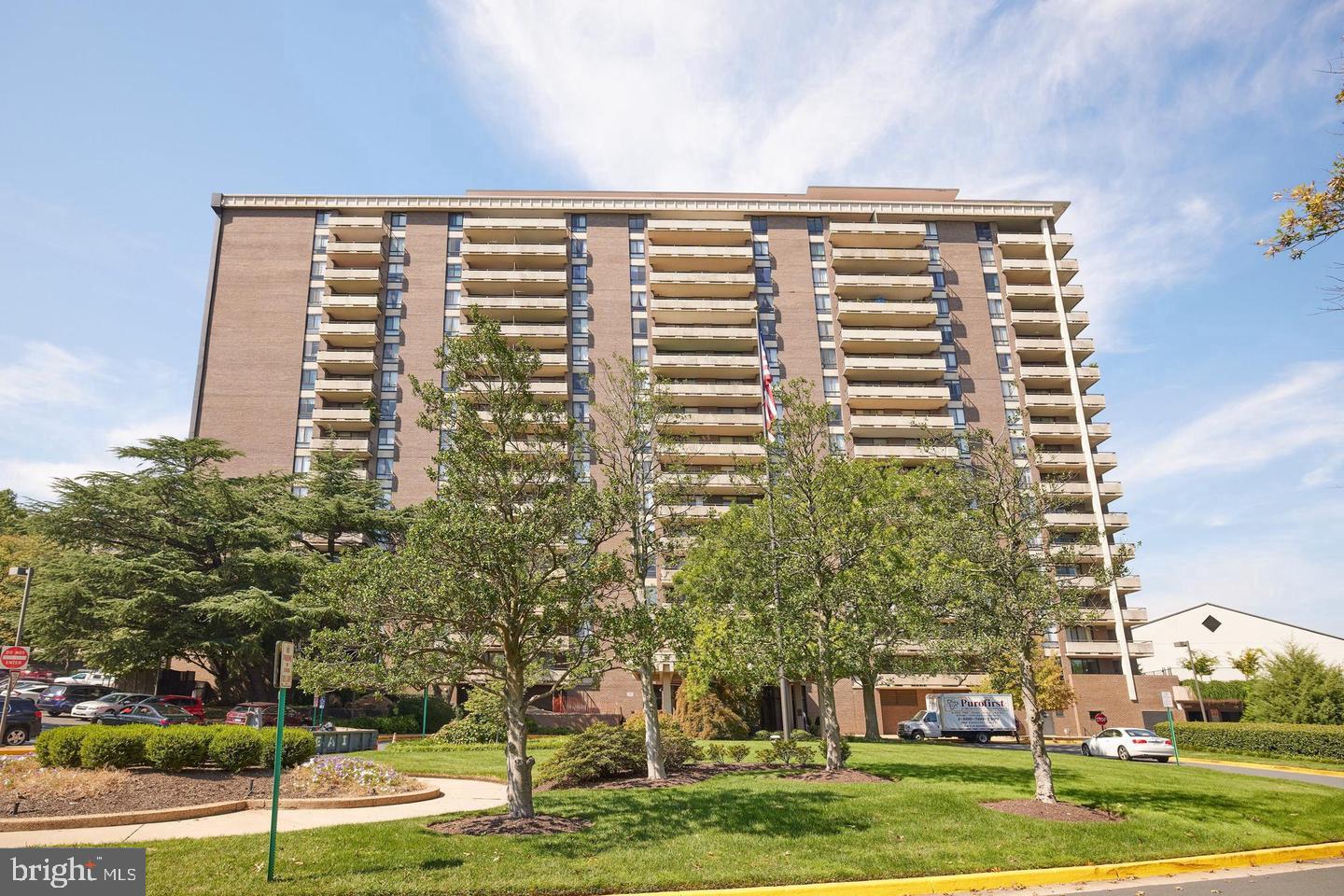 1800 Old Meadow Road, Unit 1017 McLean, VA 22102 - Photo 23 of 31 front view of a building with a yard
