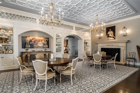 a view of a dining room with furniture a chandelier and wooden floor