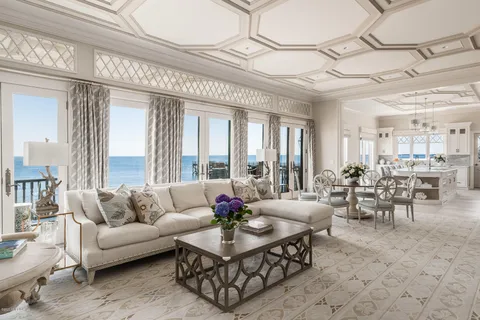 a living room with furniture and a chandelier