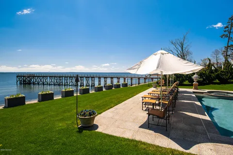 a view of a house with backyard sitting area and garden