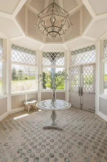 a view of a room that has a window and a table in it