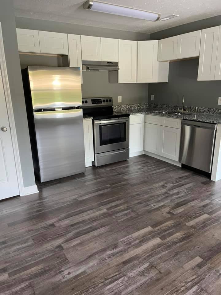 130 Main Street South, Unit 1 Carthage, TN 37030 - Photo 2 of 9 a kitchen with stainless steel appliances a stove a sink and a refrigerator