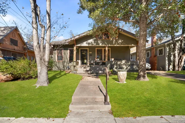 a view of a patio with couches and a table and chairs with plants and garden