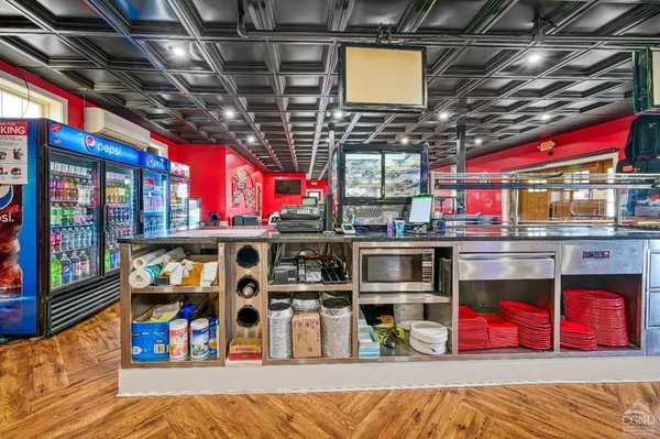 a kitchen with stainless steel appliances granite countertop a sink and a refrigerator