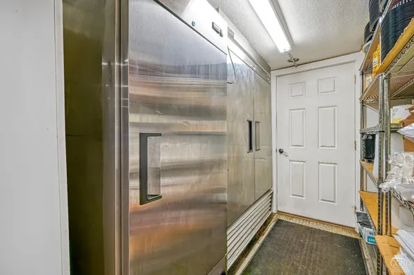 a kitchen with a stove a sink and a refrigerator