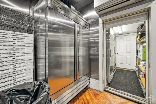 a kitchen with granite countertop stainless steel appliances a refrigerator cabinets and a sink