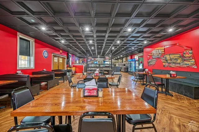 a view of a cafe with a table and chairs under an umbrella