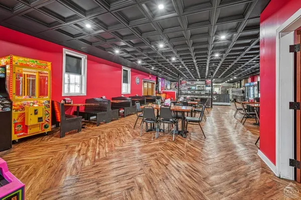 a front view of multi story residential apartment building with retail shops