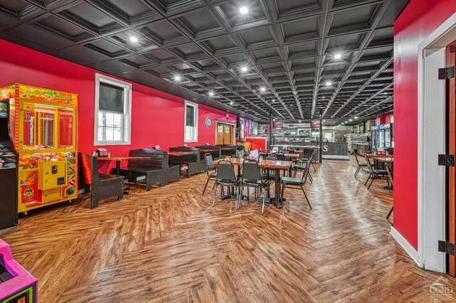 a front view of multi story residential apartment building with retail shops