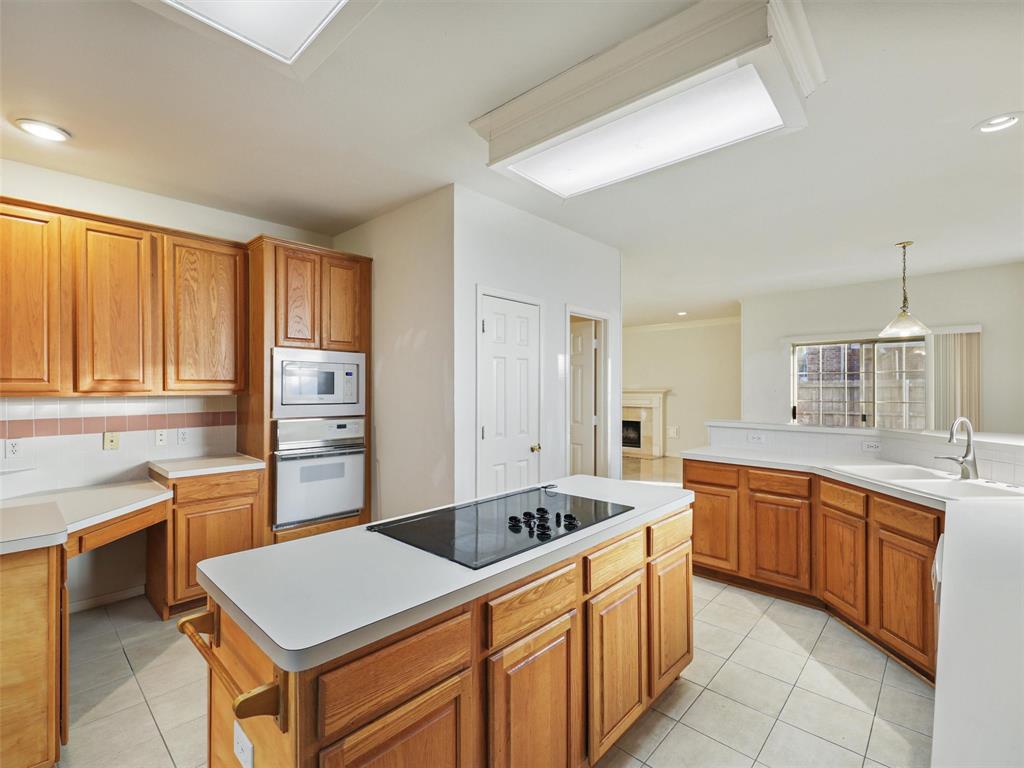 a kitchen with stainless steel appliances granite countertop a sink and dishwasher a refrigerator with wooden cabinets