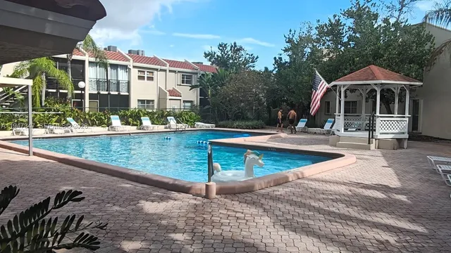 swimming pool view with a seating space