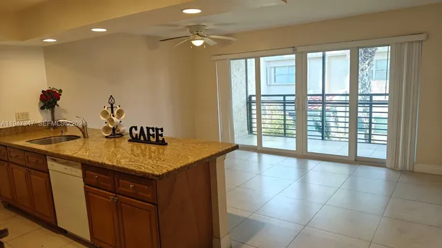 a kitchen with a sink and a large window