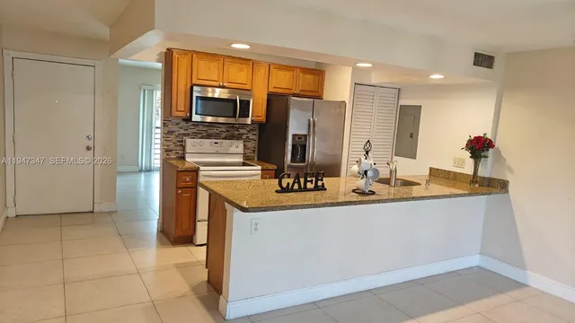 a kitchen with stainless steel appliances a sink stove and refrigerator